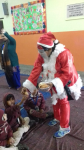 cake being distributed among the children, to enhance the fun and frolic of Christmas